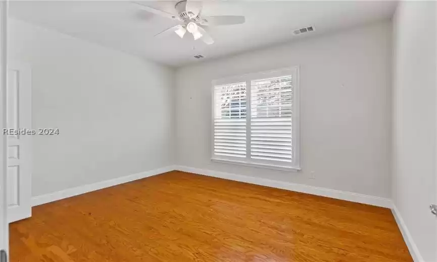 Empty room featuring light hardwood / wood-style flooring and ceiling fan