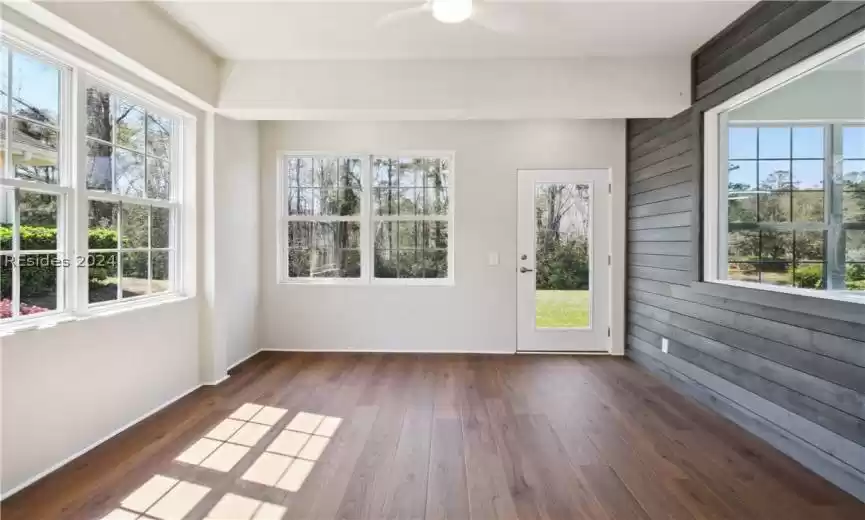 Unfurnished sunroom featuring ceiling fan and a healthy amount of sunlight