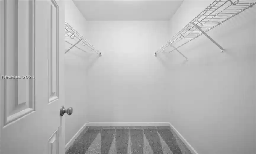 Walk-in-closet in primary bedroom