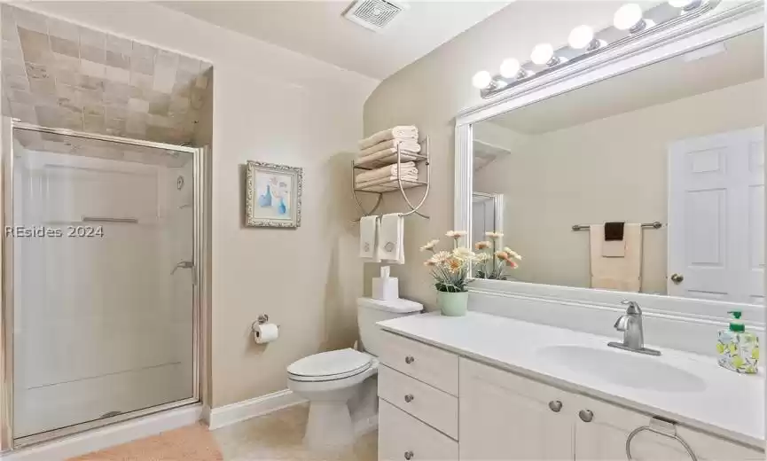 Bathroom on top floor for primary bedroom 2, with toilet, tile flooring, a shower, and oversized vanity
