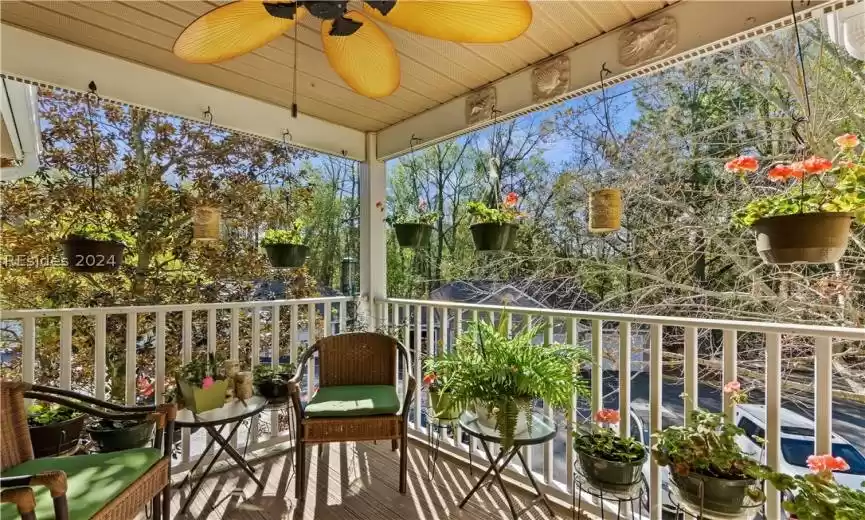 Sunny enclosed porch off the living room surrounded by trees. There is a great storage closet there too.