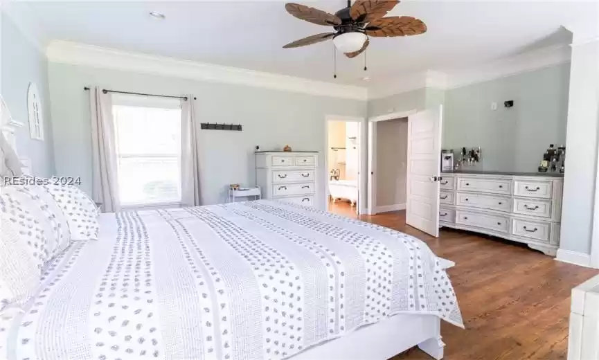 Bedroom with crown molding and ensuite bathroom.