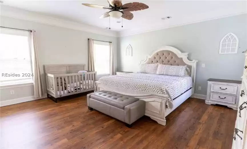 Primary bedroom with crown molding.