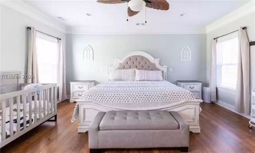 Primary bedroom with crown molding.