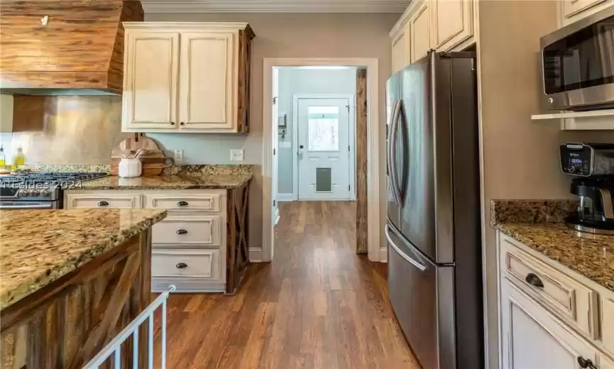 Hallway extends to a spacious pantry, and side exit to the garage and carport. To the right of the exterior door is a separate room with a beautiful tiled pet wash station.