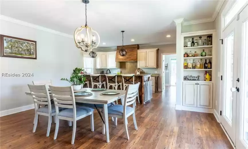 Dining area featuring with built-ins leads to the gourmet kitchen.