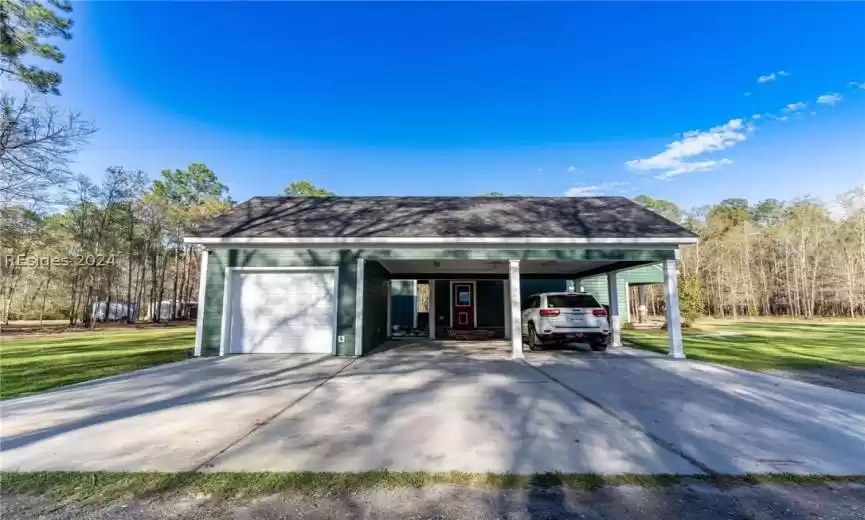 Garage featuring carport