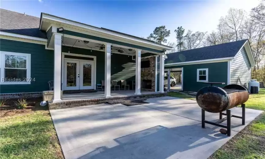 Covered back porch with fireplace.