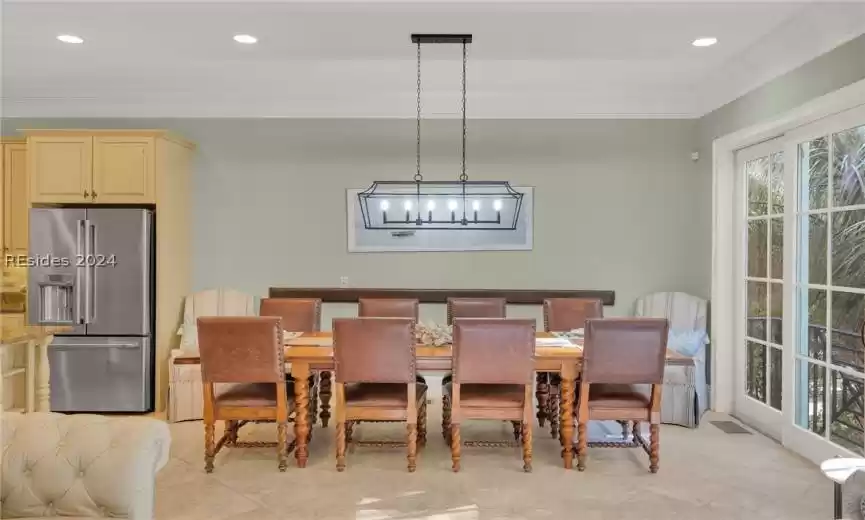 Dining room featuring stone  floors, plenty of natural light & crown  molding