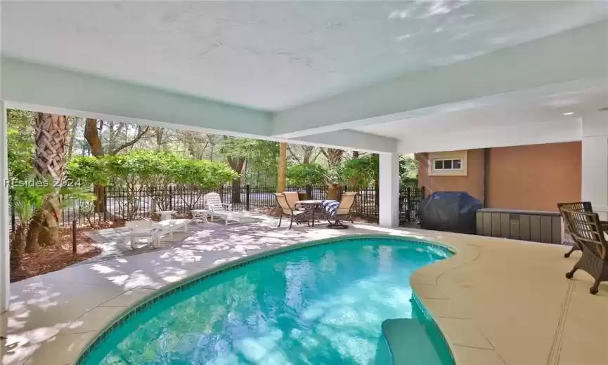View of pool featuring a patio area and a grill