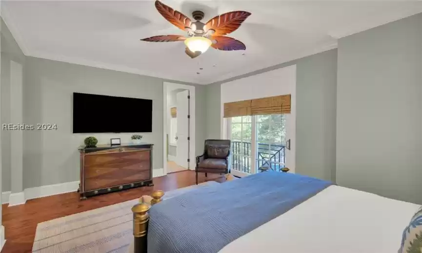 Bedroom with ensuite bathroom, hardwood floors, crown molding