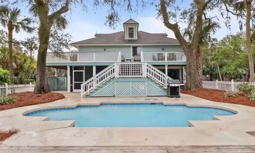 Back elevation that shows pool.