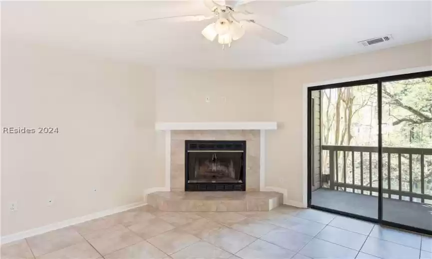 Living Room with wood burning fireplace- private balcony located right off of living area overlooking the lake.