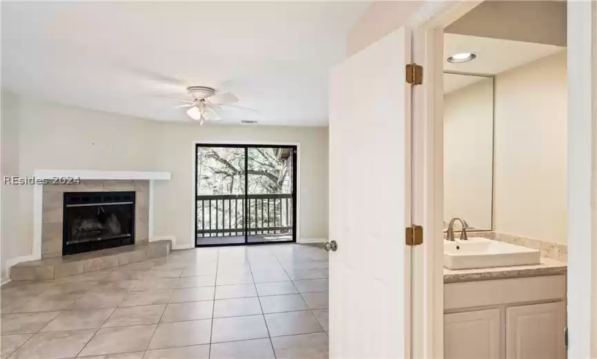 Spacious living area, with wood burning fireplace. Owner has never used. Half bath also has the Cambria Quartz counters as well with a raised vessel sink.