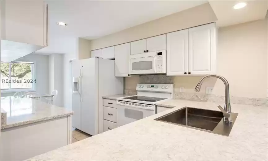 Breathtaking quartz Cambria countertops in this villa's kitchen - a must see!