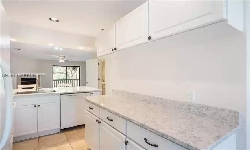 Stunning quartz countertops with white solid wood cabinetry.