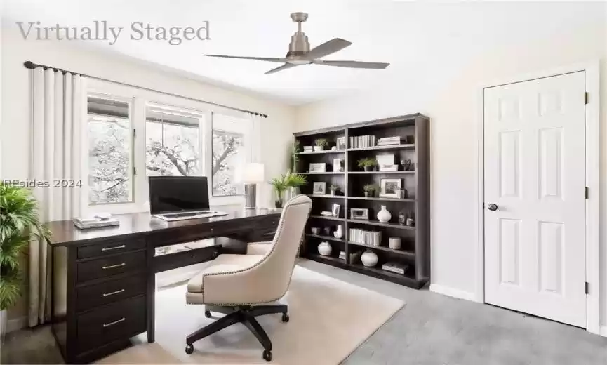 Virtually staged last bedroom staged as an office.