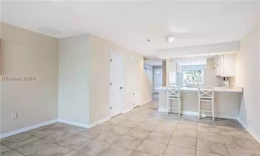 Another view of living room with view of Cambria quartz kitchen bar.