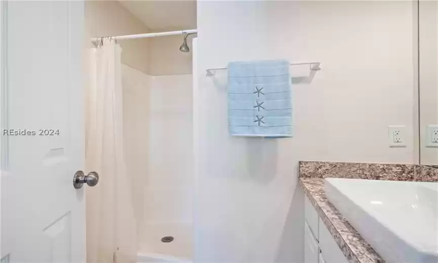 Bathroom with built in stand in shower.