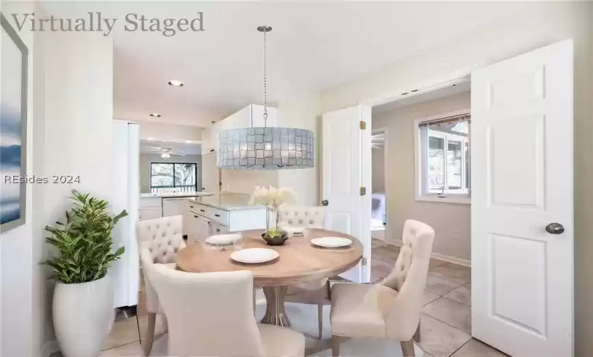 Virtually staged dining area with modern fixtures and features.