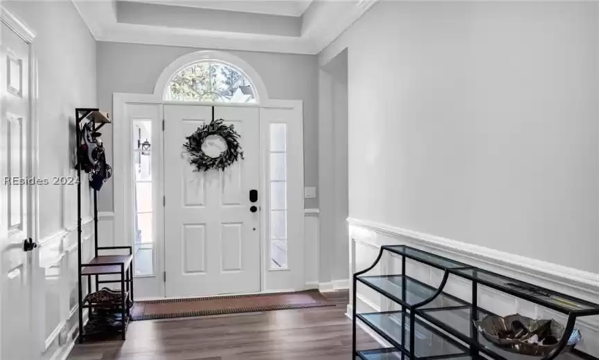 Enter the foyer with attractive crown molding and luxury vinyl plank flooring. (LVP flooring in 2022)