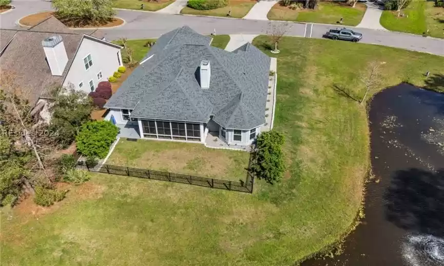 Lovely four season enclosed porch with vinyl tinted 20x8 coverings, fans, shades, new lights, double-locked door, double paned, travertine tile & NOTE: 4 season porch has its own HVAC system.
