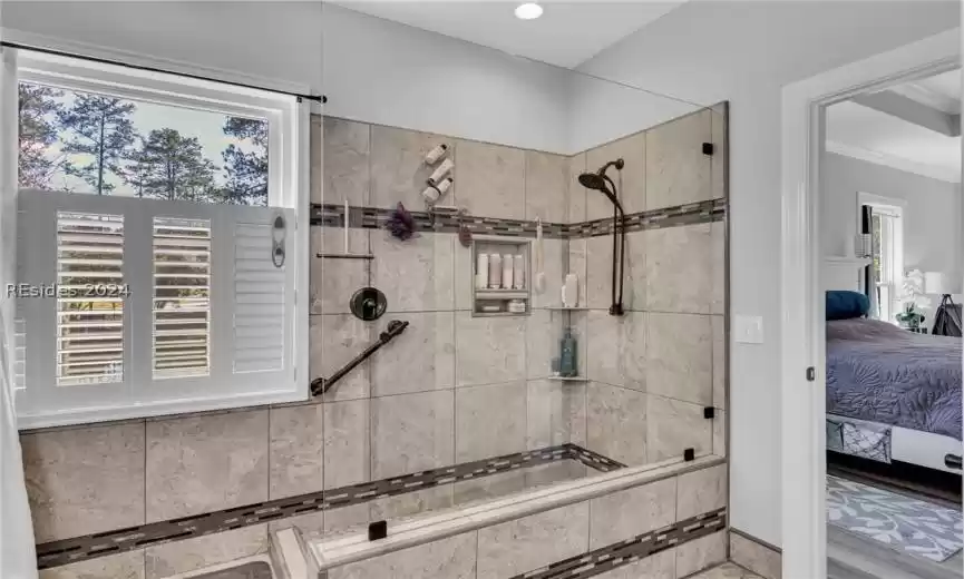 Very spacious master bedroom with lots of windows, tray ceiling, ceiling fan with light. (The LVP flooring continues to sparkle and shine).