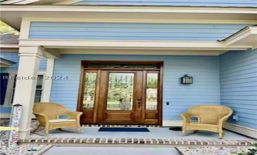 Close-up of front entry, door and covered porch.
