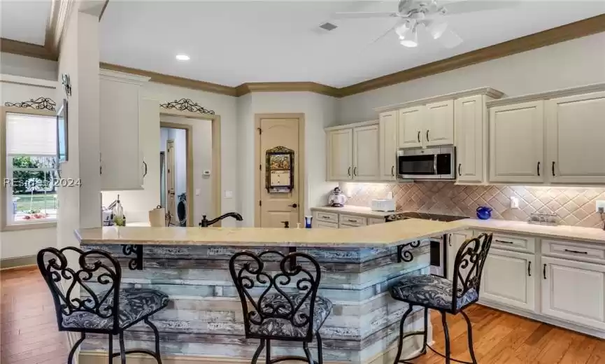 Light and bright kitchen features maple cabinets with soft close doors and drawers
