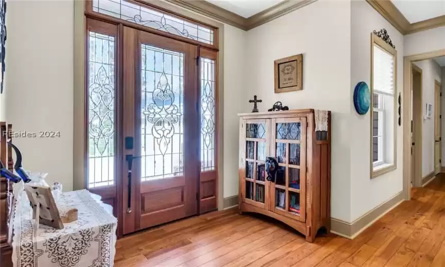 Attractive foyer and upgraded front door with surround transom glass professionally refinished.