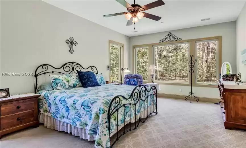 Spacious master bedroom was bumped out an extra 8 feet at time of construction, features wall of large windows and room for a sitting area.