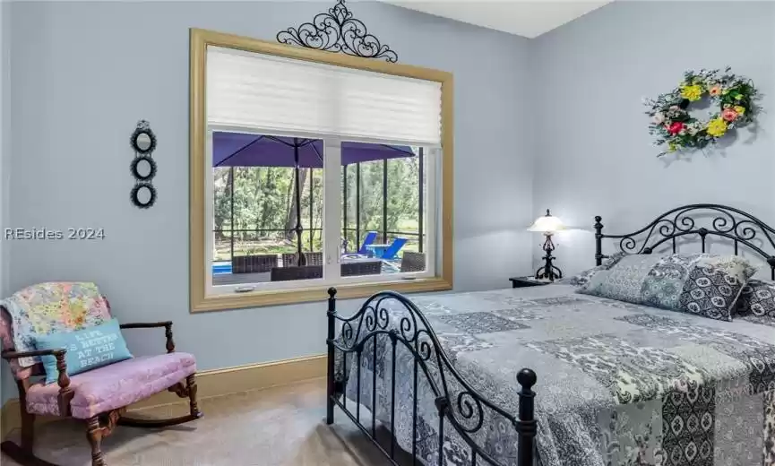 Spacious guest bedroom with large double window.
