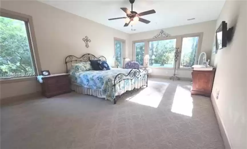 Another look at this spacious master bedroom with large windows that let in the natural light.