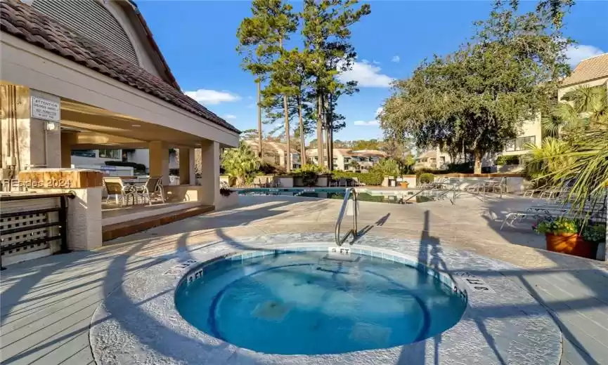 View of pool featuring a hot tub and a patio