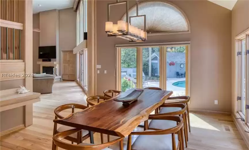 Dining area featuring light hardwood / wood-style floors and a high ceiling