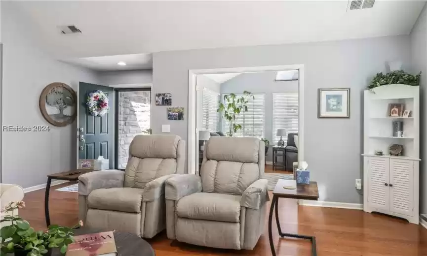 Living room with dark hardwood / wood-style floors