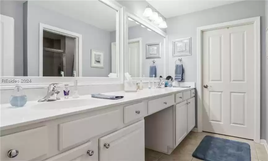 Bathroom with double sink, oversized vanity, and tile flooring