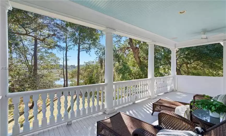 Sunroom with ceiling fan and a wealth of natural light