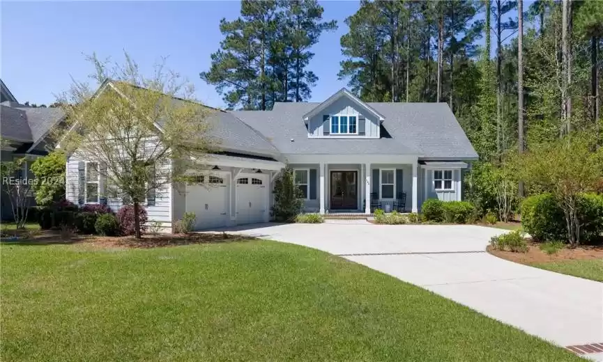 View of front of home with a front yard and a garage