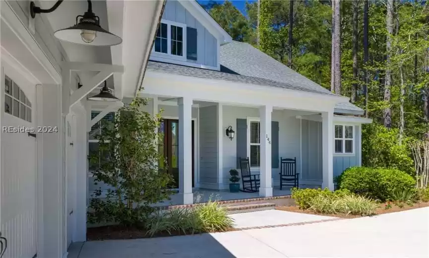 View of exterior entry featuring covered porch