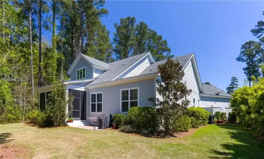 View of property exterior featuring a yard