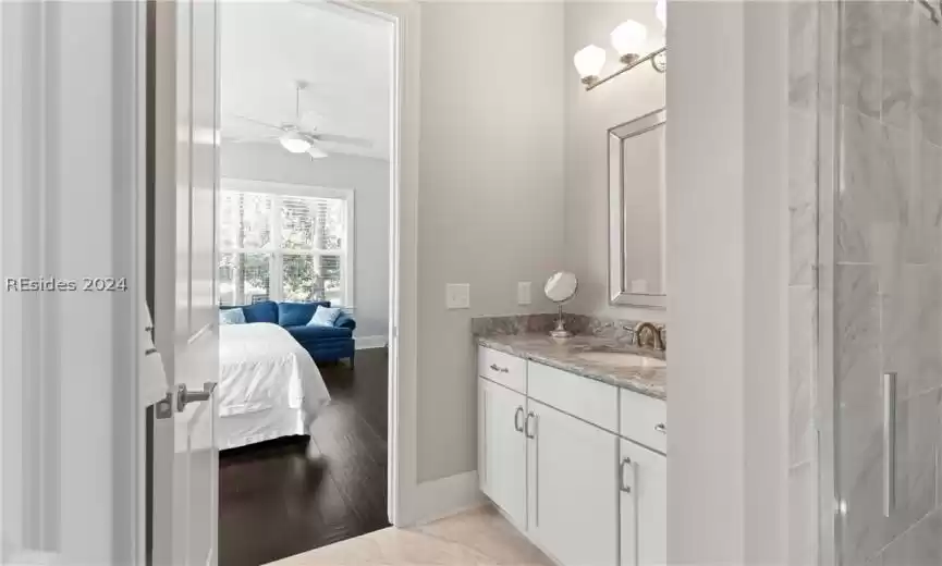 Bathroom featuring tile floors, oversized vanity, and ceiling fan