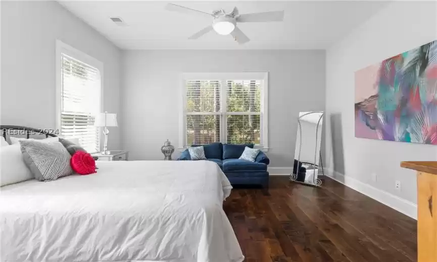 Bedroom with ceiling fan and dark wood-type flooring