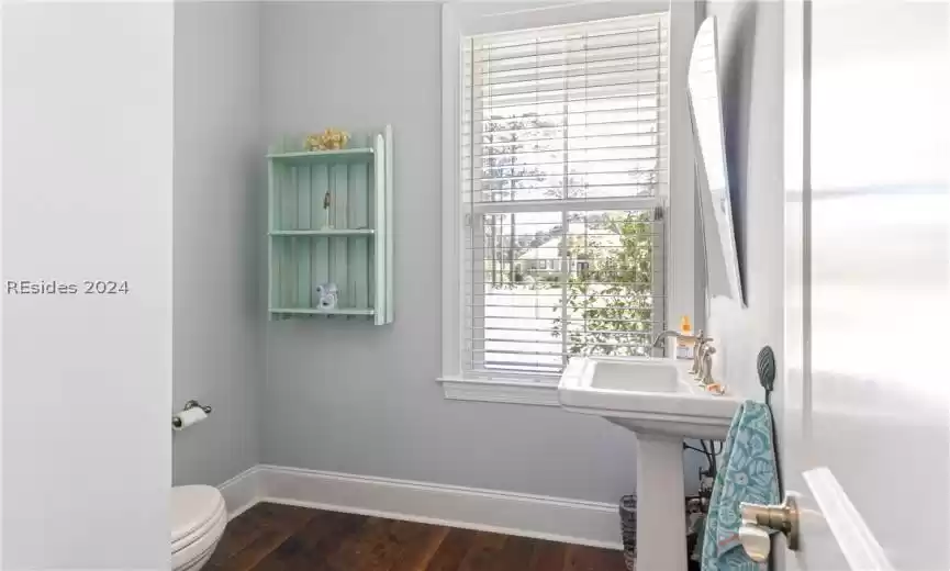 Bathroom featuring hardwood / wood-style floors and toilet