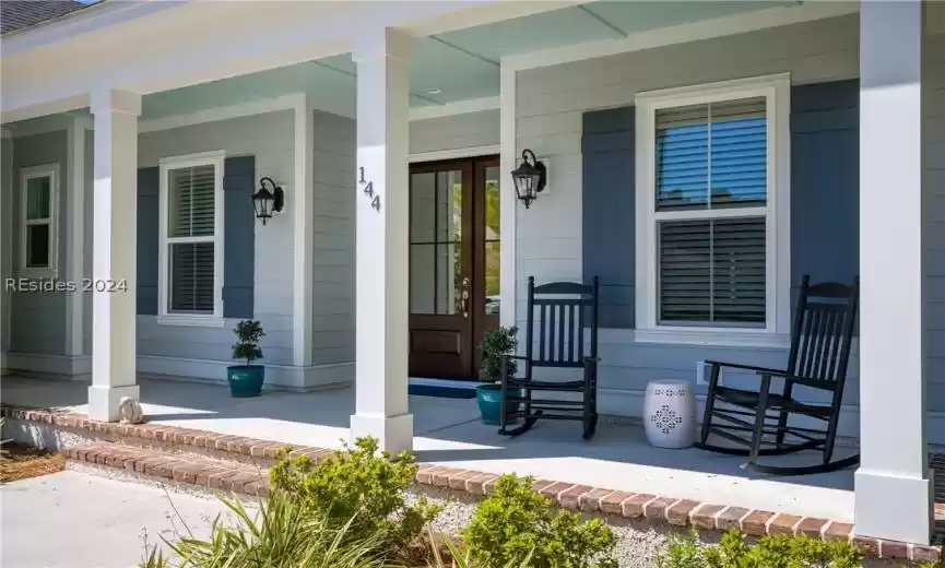 Doorway to property with covered porch