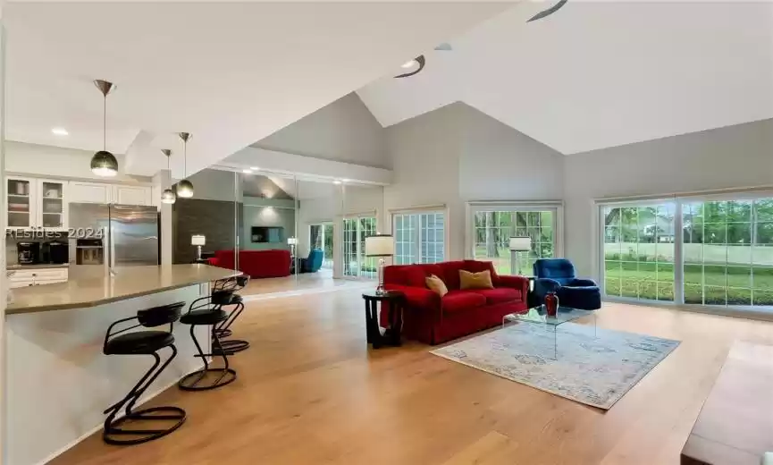 View of great room and dining room behind sofa