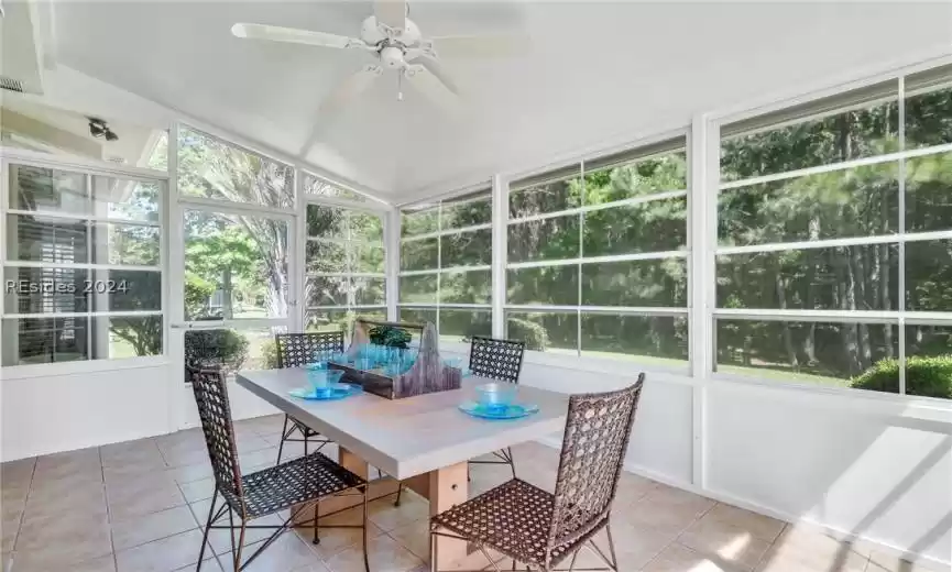 Sunroom featuring ceiling fan and lofted ceiling