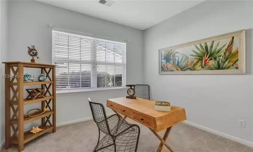 Freshly painted and carpeted den/office with closet