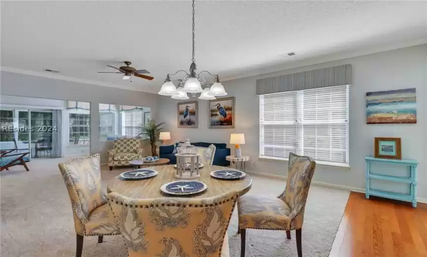 Plenty of natural light, and ceiling fan with notable chandelier