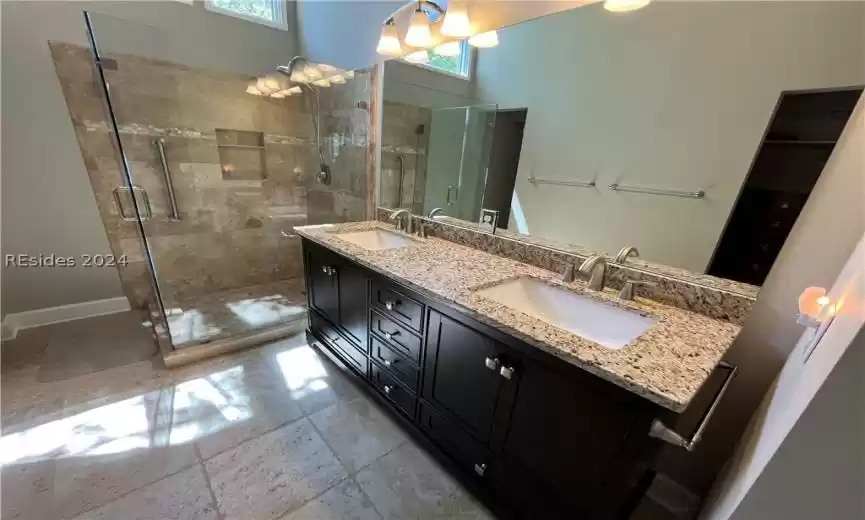 Bathroom featuring vanity and an enclosed shower